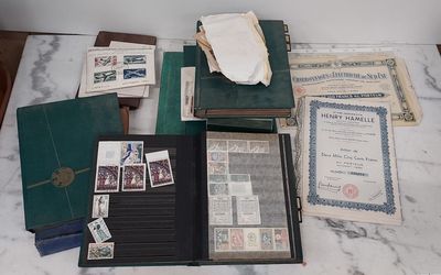 a lot of old papers and stamps on a table