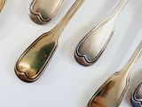 five spoons that are sitting next to each other on a table
