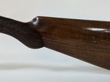 a close up of a rifle on a white surface with a white background