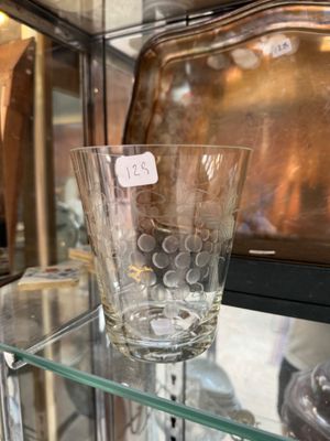 a glass vase sitting on a glass shelf in a glass case