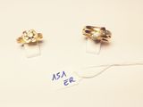 two gold rings and a diamond ring on a white surface
