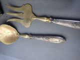 two spoons and a fork sitting on a table