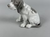 a figurine of a dog sitting on the ground