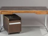 an image of a desk with a file cabinet underneath it