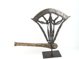 a metal sculpture of a baseball bat on a stand