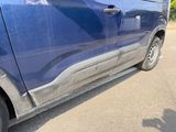 a blue van parked on the side of the road