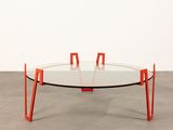an image of a glass table with orange legs and a glass top