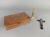 a small wooden box with a cross on top of it
