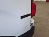 the rear end of a white van with a sticker on it