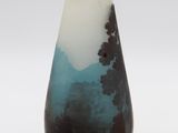 a black and white vase sitting on a white surface