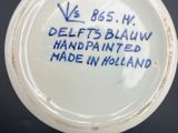 a white bowl with blue writing on it on a table