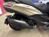 a silver and black motorcycle parked in a garage
