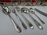 a lot of silver spoons and spoons on the table