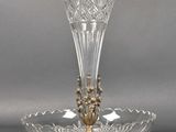 a glass vase on a stand on a gray background
