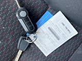 a picture of a car seat with a car key and a ticket