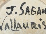 a sign that says j sean vallauas on the side of a building