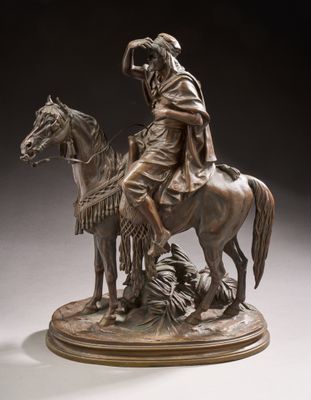 bronze statue of a man on a horse with a woman on a horse