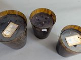 three wooden buckets with labels on them sitting on a table