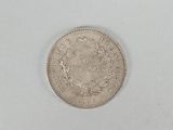 a close up of a coin on a white surface with a white background