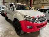 a picture of a red and white truck parked in a garage