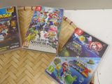 three nintendo wii games sitting on top of a table next to each other