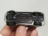 a person holding a small toy car in their hand