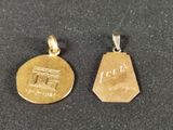 two pieces of gold are shown on a black surface