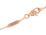 a close up of a gold bracelet with a diamond on it