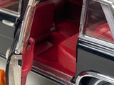 a close up of a car door with a red seat in it