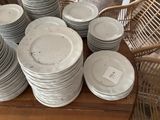 many plates stacked on a table with a price tag on them