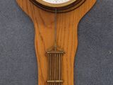 two clocks hanging on the wall next to each other