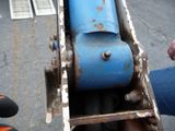 a close up of a blue machine on a street