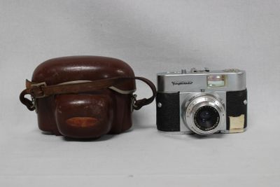 a brown camera and a brown bag on a white background