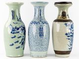three vases sitting next to each other on a white surface