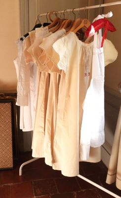 a lot of clothes hanging on a rack in a room