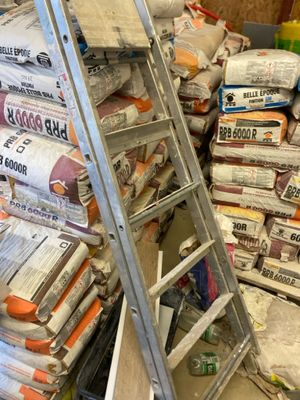 a ladder that is next to a pile of construction materials