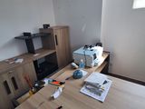 a desk with a printer, printer and other items on it