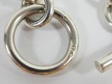 a close up of a chain and a key on a table
