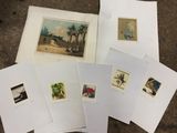 several prints of different types of art are on a table