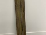 an old wooden door leaning against a wall in a white room
