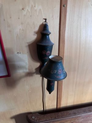 a clock hanging on the wall next to a lamp