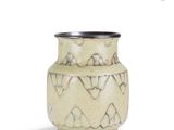 a vase that is sitting on a white surface