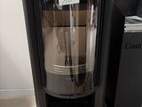 a black stove with a glass door in a room