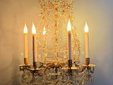 a chandelier with three candles hanging from it