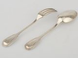 pair of silver plated spoons and a fork on a white surface