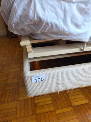 a bed that has a white cover on it