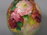 a vase with flowers painted on it sitting on a table
