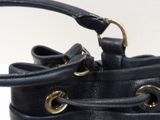 a close up of a black purse with a gold handle