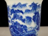 a blue and white cup sitting on a table