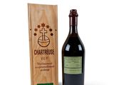 the bottle of wine is next to a wooden box